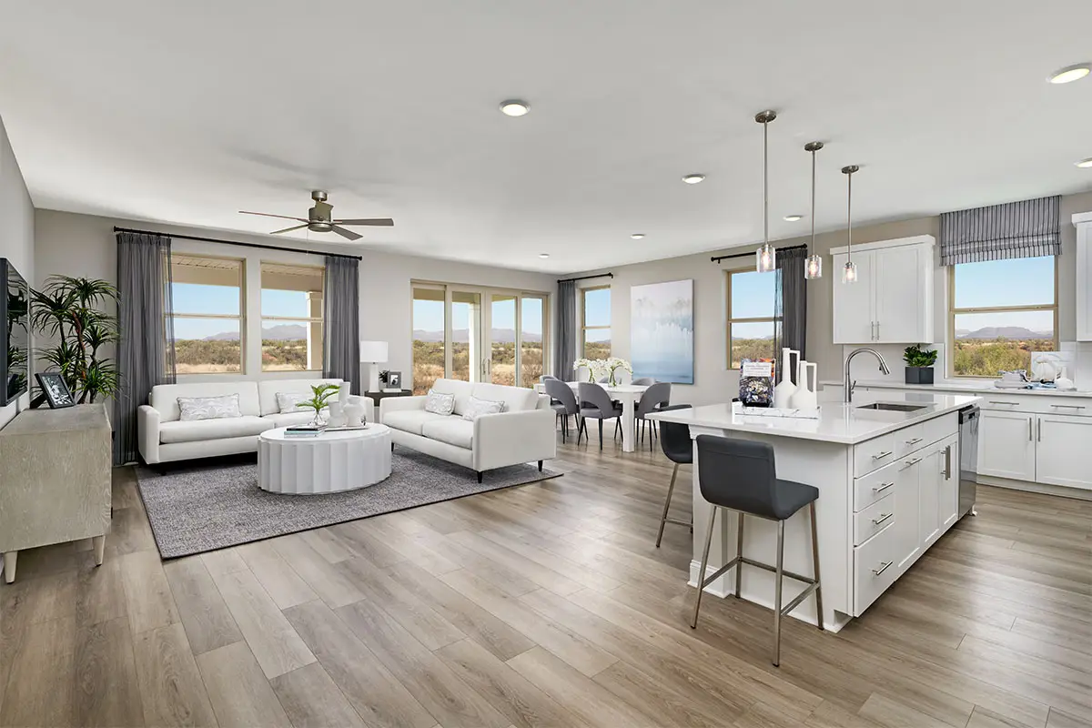 Great room with hardwood flooring, kitchen island and many windows