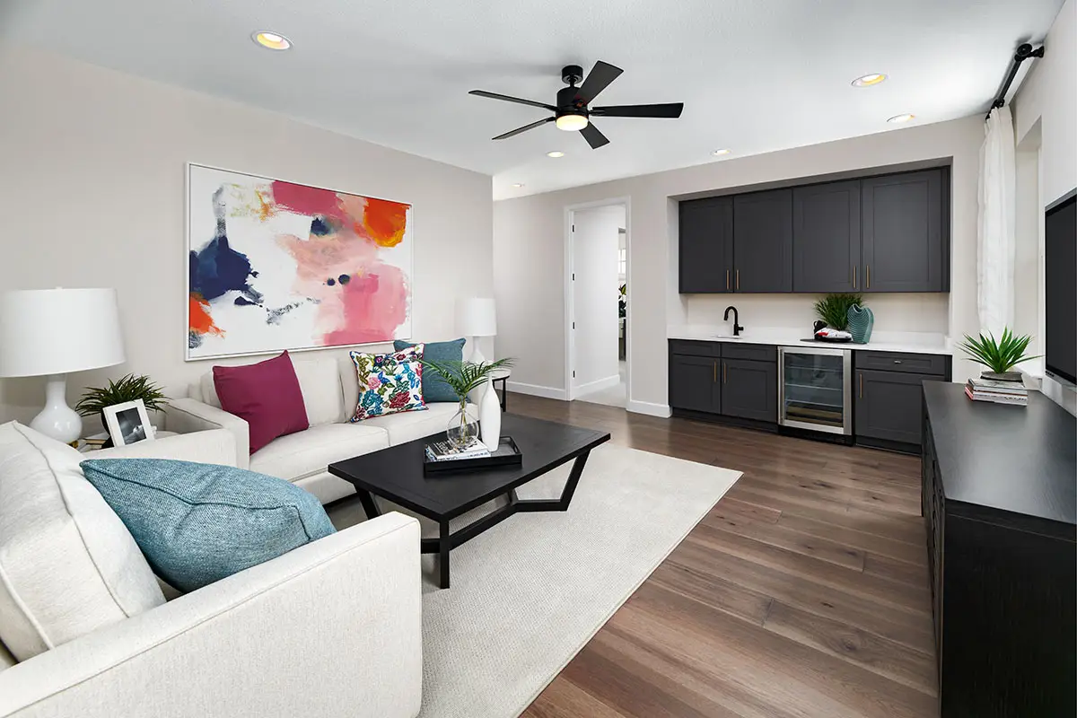 Guest suite with couch, tv and hardwood flooring