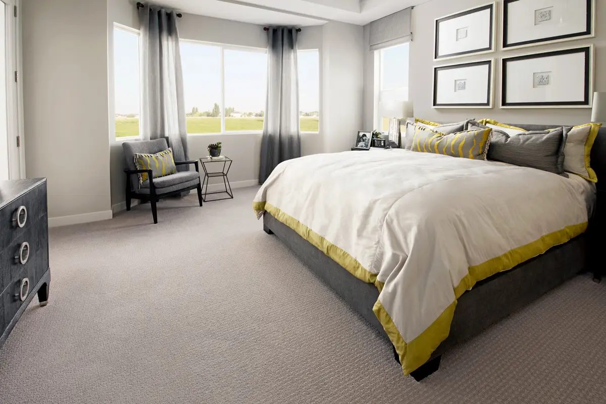 Primary bedroom with Mohawk carpet and a bed